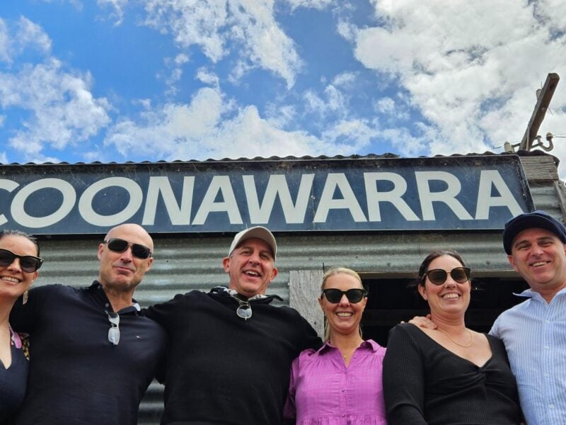 Group of people standing under the Coonawarra sign