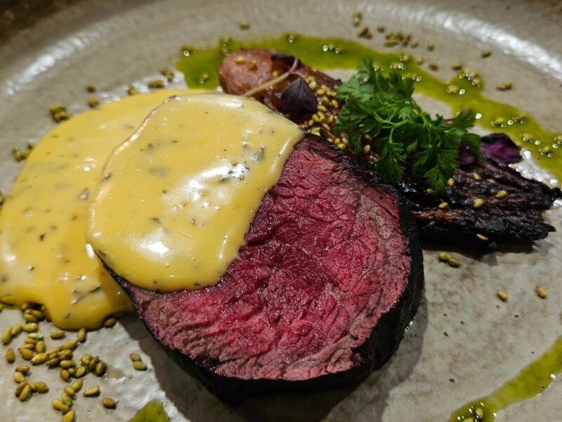 Coonawarra Experiences – Rare wagyu with béarnaise sauce, veg, herb oil, and seeds.