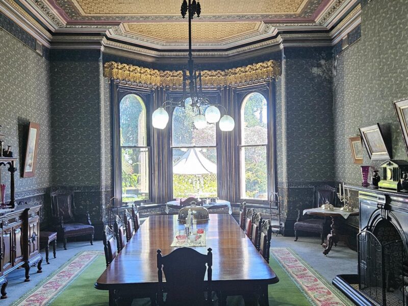 A grand dining room with a long table and Victorian-era decor at Yallum Park.