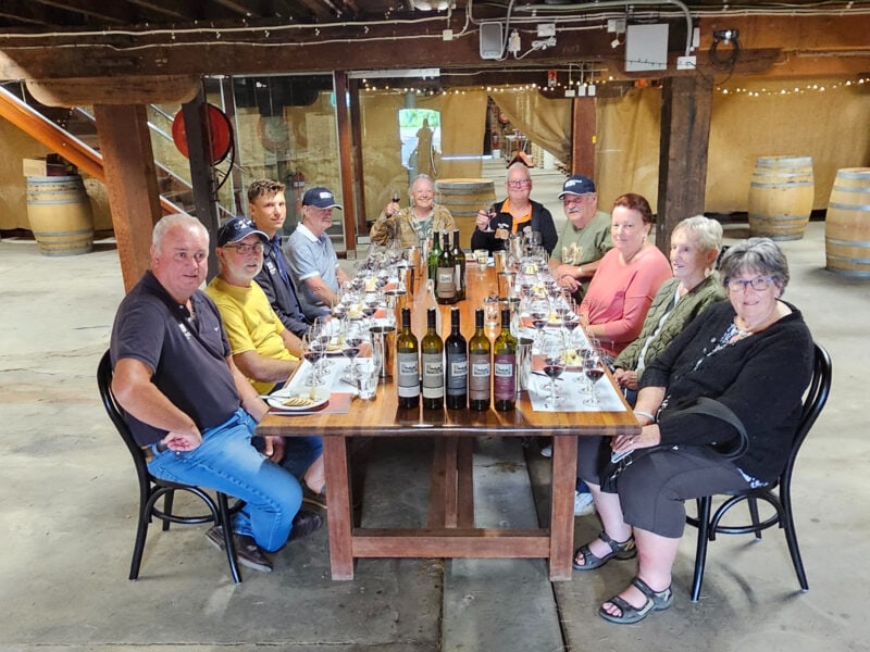 Group of people in a wine cellar tasting wines