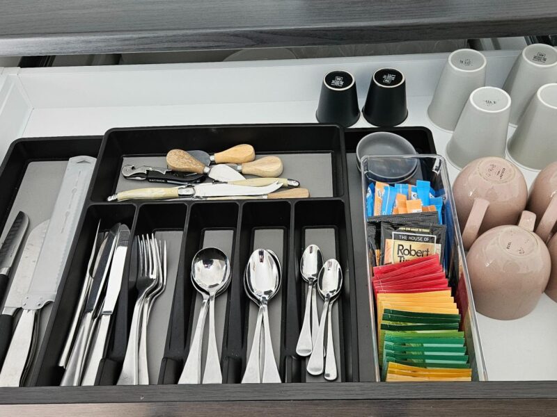 Coonawarra Experiences well-stocked kitchen drawer with cutlery, mugs, tea, and Nespresso coffee pods.