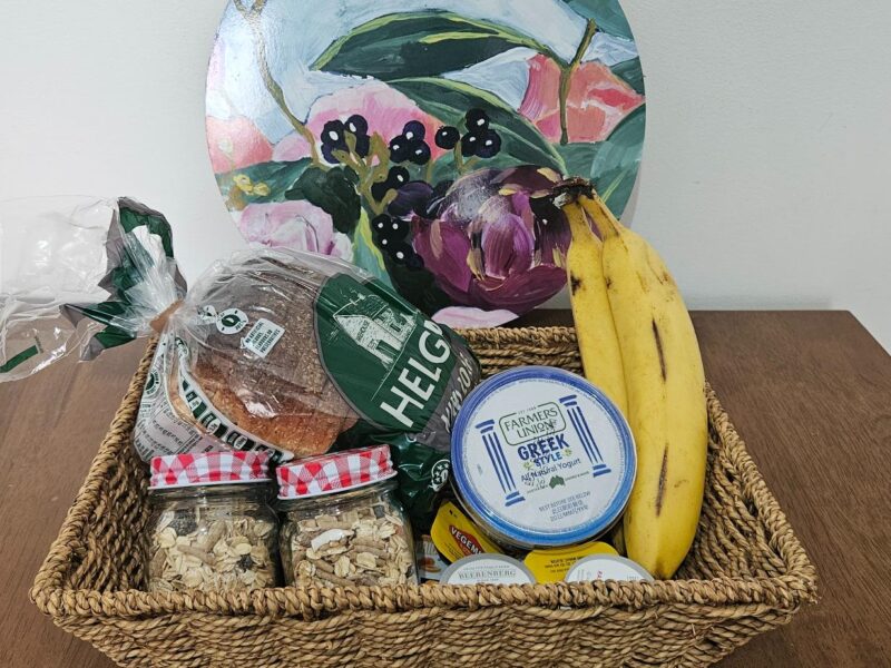Coonawarra Experiences welcome hamper with bread, muesli, bananas, Greek yoghurt, and local condiments.