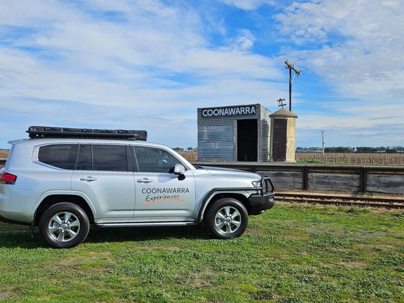 Side view of luxury 4WD with Coonawarra Experiences branding near siding