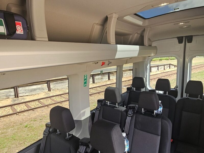 Interior seating and skylight roof inside Ford Transit tour vehicle
