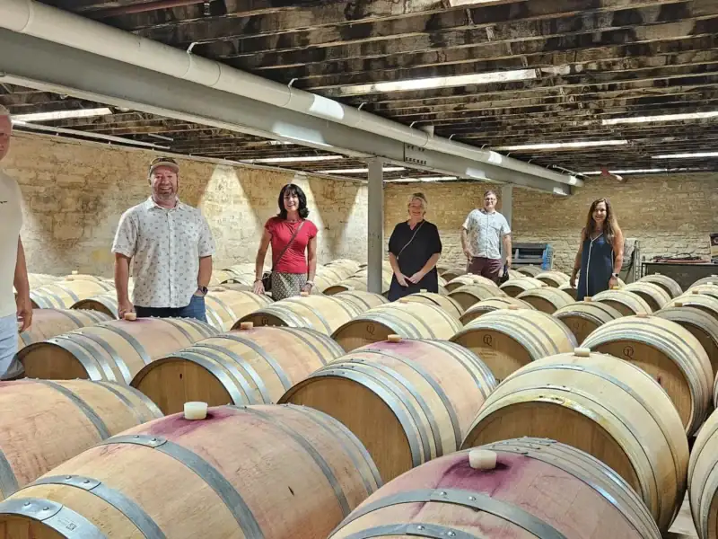 Guests exploring a barrel cellar during a hosted Coonawarra winery tour
