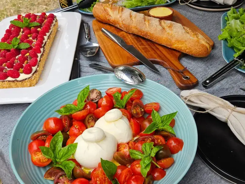 Local produce lunch with fresh tomatoes, burrata, bread and salad