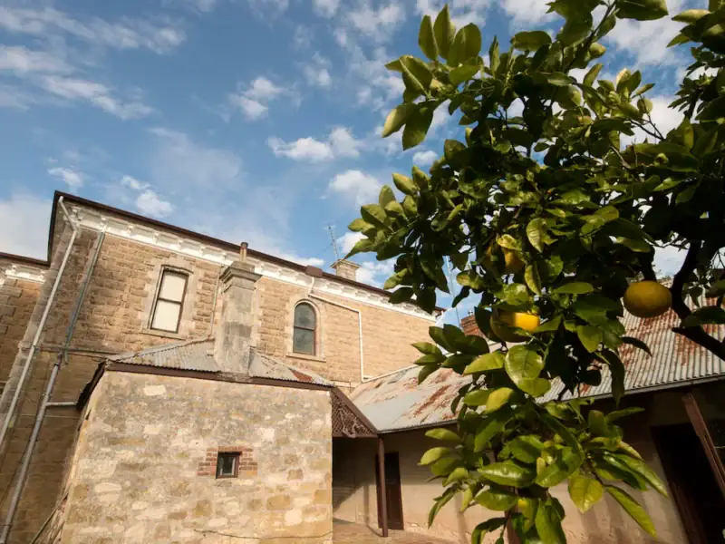 Side view of Yallum Park homestead with original stonework and lemon tree